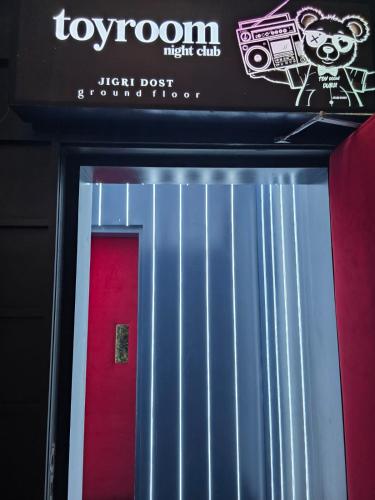 a sign above a red and blue door at Gulf Inn Hotel Al Nasr Formerly Roda Links Al Nasr in Dubai
