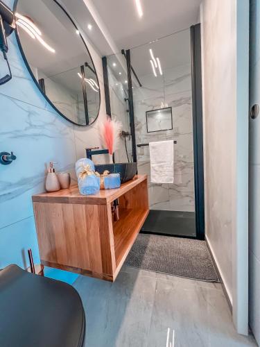 a bathroom with a sink and a mirror at Apartment Sova or Deluxe room 33 in Bled