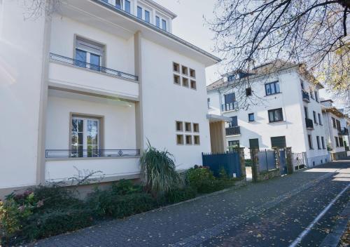 a row of white buildings on a street at Charmant appartement avec terrasse dans villa in Strasbourg