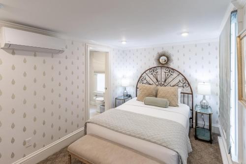 a bedroom with a large white bed and a window at Serenity Inn Newport in Newport