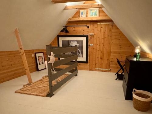 a attic room with a ladder in a house at Erve Soebringe in Ansen
