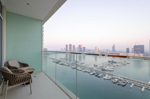 a balcony with a view of a marina at Seaside Serenity Perfect Beachfront Holiday Haven in Dubai