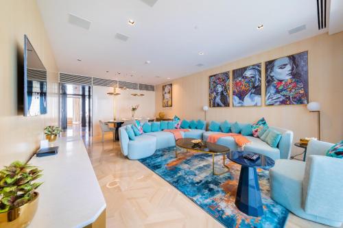a living room with a blue couch and a blue rug at Superluxury Apartment in FIVE Palm, Pool & Beach Access in Dubai