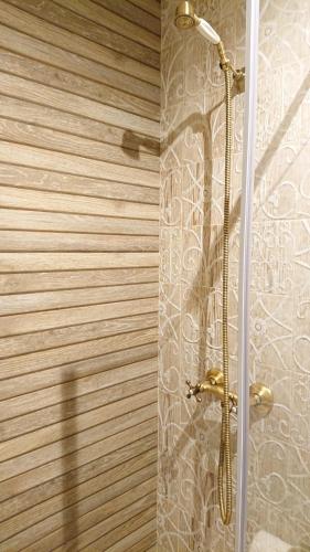 a shower in a bathroom with a glass door at Casa Antón O Cebreiro in O Cebreiro