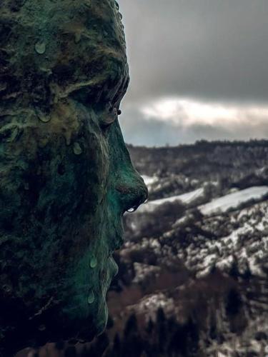 a statue of a face with water drops on it at Casa Antón O Cebreiro in O Cebreiro