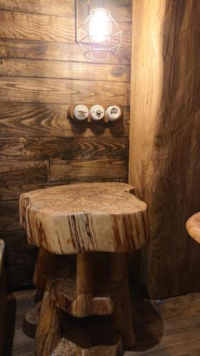 a wooden room with a wooden table and a bench at Casa Antón O Cebreiro in O Cebreiro