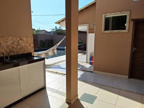 a kitchen with a view of a house at Casa Sauê in Aracruz