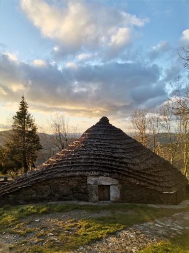 an old stone building with a grass roof at Casa Antón O Cebreiro in O Cebreiro