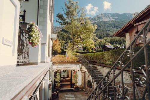 a view from the balcony of a house with stairs at Villa Novecento Romantic Hotel - Estella Hotel Collection & Experience in Courmayeur