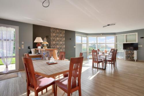 une salle à manger et un salon avec une table et des chaises dans l'établissement Dans la campagne d'Erquy, grande maison pour 6, à Erquy