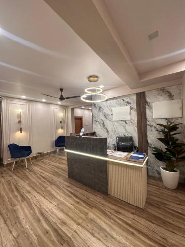 an office with a reception desk and blue chairs at Jagannath Residency And Prasadam in Kolkata