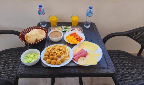 a tray of food on a table with plates of food at pyramids rose view inn in Cairo