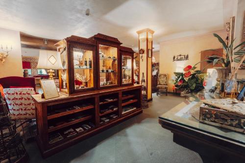 a room with a large wooden cabinet in a store at Villa Novecento Romantic Hotel - Estella Hotel Collection & Experience in Courmayeur