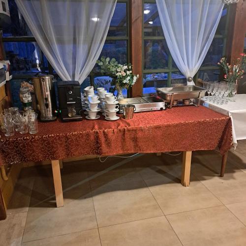 a table with a red table cloth on it at Dom myśliwski in Mosty