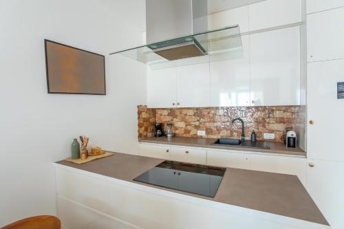 a kitchen with a sink and a counter top at The Dream Getaway & Spa by DeVasco in Becici