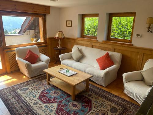 a living room with two couches and a coffee table at Chalet Genziana in Cavalese