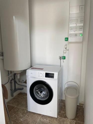 a washer and dryer in a corner of a bathroom at Maison splendide avec piscine in Ribérac