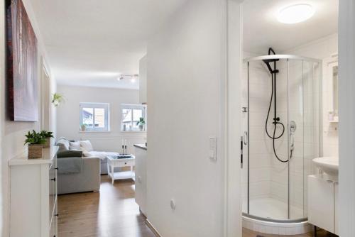 a white bathroom with a shower and a sink at Alsfelder Wein-Suite in Alsfeld