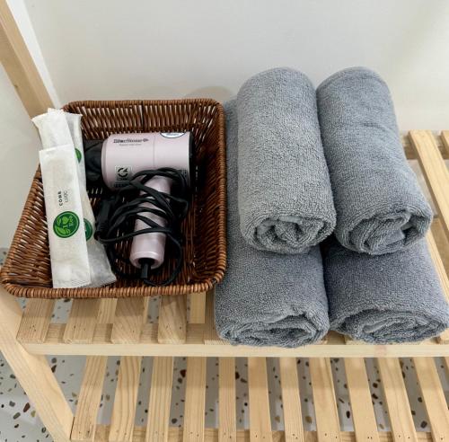 a basket filled with towels and a hair dryer at NẮNG Homestay - Làng Chài Mũi Né - Mui Ne Fishing Village in Mui Ne