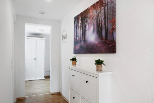 a white room with a painting on the wall at Alsfelder Wein-Suite in Alsfeld