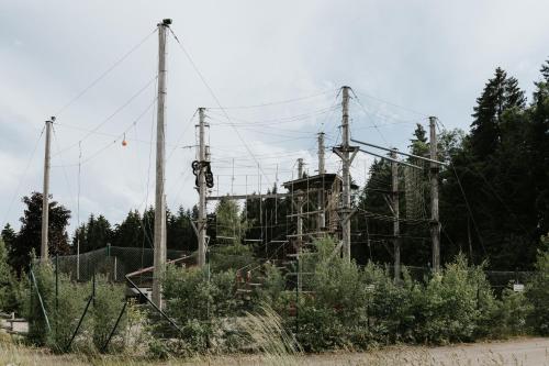 a group of utility poles and wires on a field at HEIMATEL - Bodensee Residenz Allgäu in Scheidegg