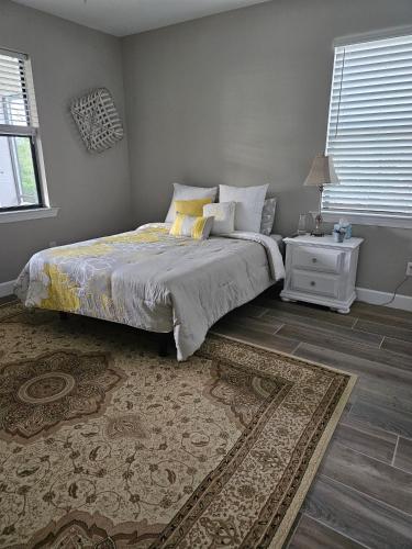 a bedroom with a bed with a nightstand and a bed sidx sidx sidx sidx at Peace and Quiet in North Port