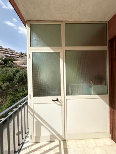 a sliding glass door on a balcony at Sillemi in Letojanni