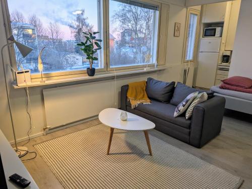 a living room with a couch and a table at Cozy apartment in Kemi City in Kemi