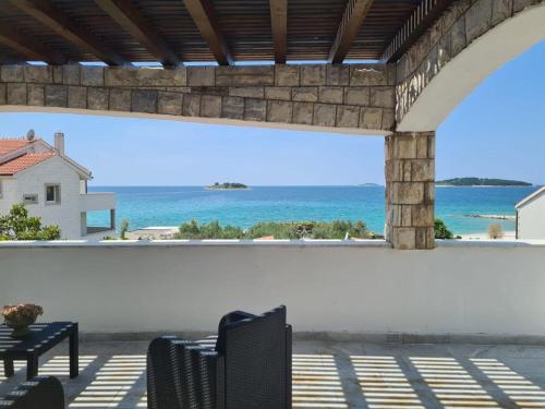 a patio with a view of the ocean at House Villa Oaza in Rogoznica