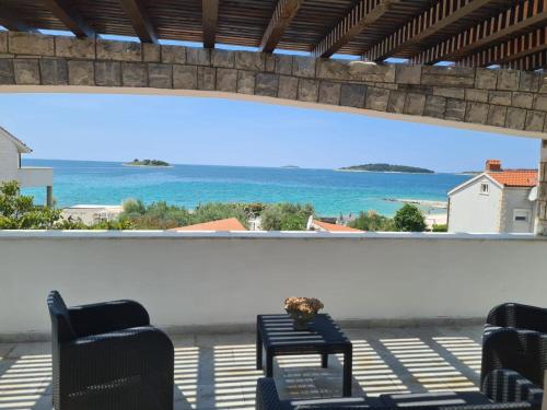 a view of the ocean from the balcony of a house at House Villa Oaza in Rogoznica
