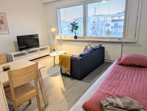 a living room with a couch and a television at Cozy apartment in Kemi City in Kemi