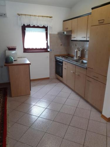 a kitchen with a sink and a stove top oven at Apartment Ani in Supetarska Draga