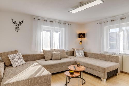 a living room with a couch and a table at Seeperle Lochau - Der See ruft! in Lochau
