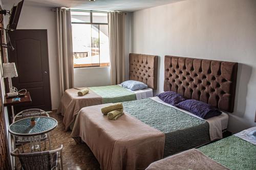 Postel nebo postele na pokoji v ubytování Huacachina Desert House