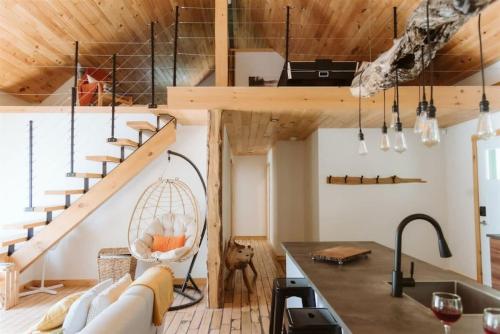 a kitchen and living room with a loft at L'Echappee Belle - lake and SPA in Saint Come