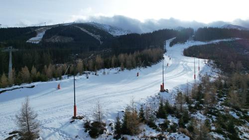 a ski slope with a ski lift in the snow at CHALET MOUNTAIN in Demanovska Dolina