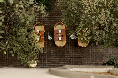 two skateboards are attached to a brick wall at Hotel Parián in Mexico City