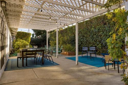 a patio with a table and chairs under a pergola at Goleta Getaway by AvantStay Private Backyard 1.5mi to the Beach in Santa Barbara