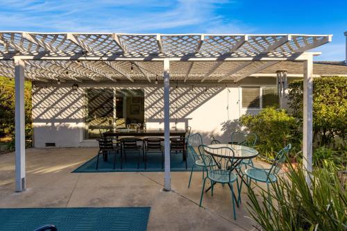 a patio with a table and chairs under a pergola at Goleta Getaway by AvantStay Private Backyard 1.5mi to the Beach in Santa Barbara