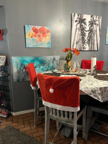 a dining room with a table with red chairs at Blue Beauty located by LSU in Baton Rouge