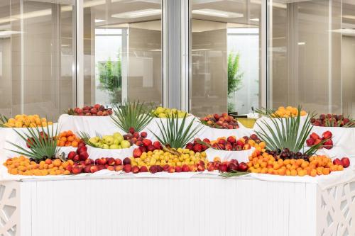 a display of fruits and vegetables in bowls on a table at VOI Alimini Resort in Alimini