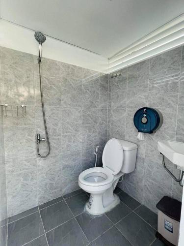 a bathroom with a toilet and a shower at Damboung Bungalow in Kampot