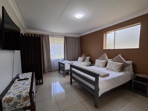 a hotel room with two beds and a window at 188 On Springs Road in Brakpan