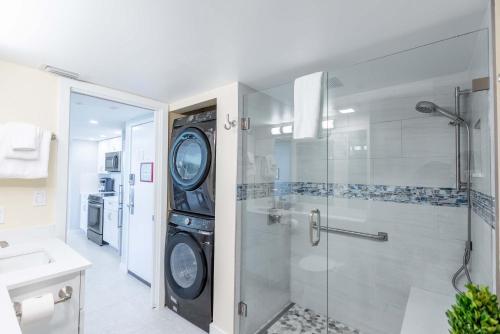 a bathroom with a washing machine and a shower at The Exuma Cay -Pool View & Parking in Key West