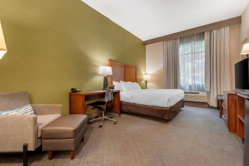 a hotel room with a bed and a desk at Comfort Inn & Suites LaVale - Cumberland in La Vale