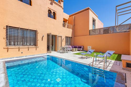 a swimming pool in front of a house at Villa Riad Targa 10 min de GUELIZ Piscine privee in Marrakech