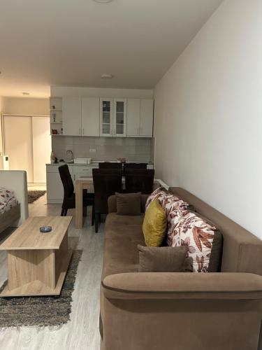 a living room with a couch and a table at Studio Djokic in Zlatibor