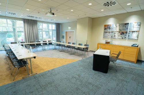 a large room with tables and chairs in it at Radisson Blu Hotel Dortmund in Dortmund