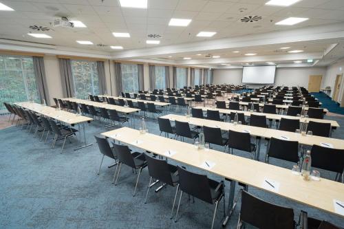 a large room with tables and chairs in it at Radisson Blu Hotel Dortmund in Dortmund
