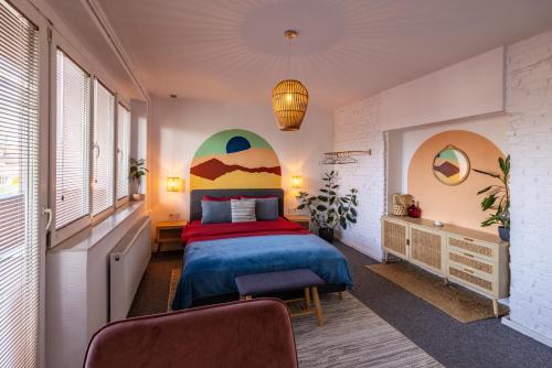 a bedroom with a bed and a large window at Sunny & Bright Central in Pristina